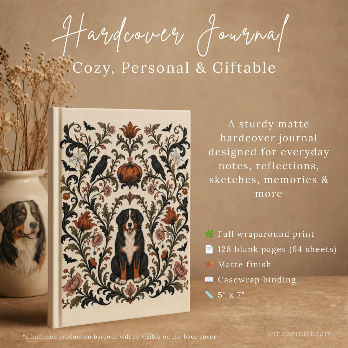  A hardcover journal featuring a symmetrical damask frame with a Bernese Mountain Dog, crows, and a pumpkin in muted autumn tones on cream, standing upright beside a ceramic vase painted with a Bernese Mountain Dog and dried florals, on a warm tan surface. Text reads "Hardcover Journal, Cozy, Personal & Giftable," with an icon list of full wraparound print, 128 blank pages, matte finish, casewrap binding, and 5 inches by 7 inches.
